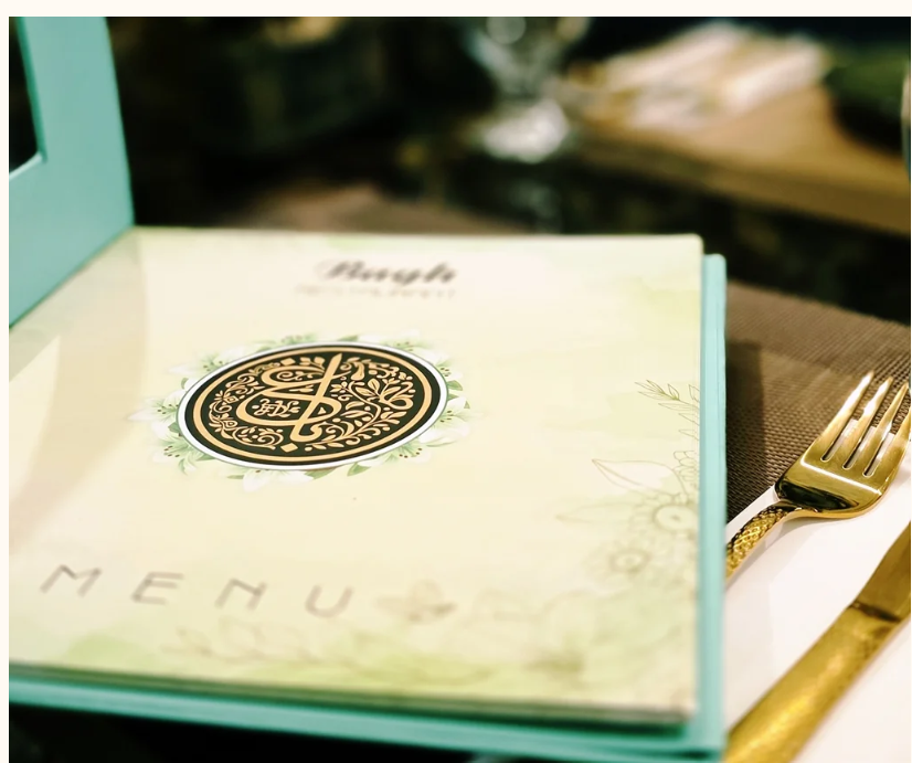 The Bagh printed menu on a restaurant table